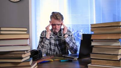 Tired and stressed young student in library