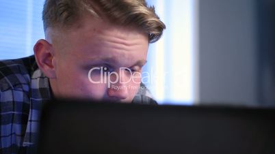 Attractive student doing schoolwork on laptop.