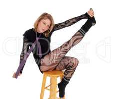 Acrobatic woman in bodysuit.