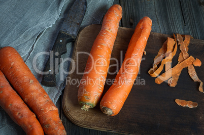 whole big carrot on the kitchen board, top view