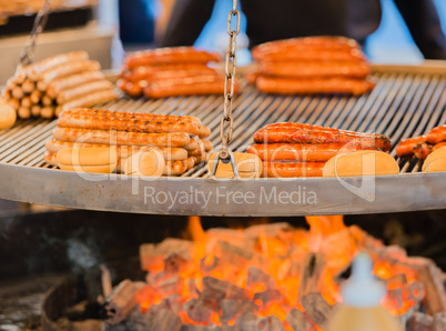 grilling fire sausage on a Christmas market