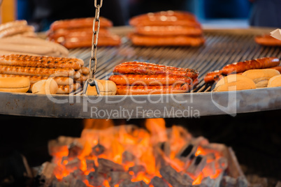 grilling fire sausage on a Christmas market