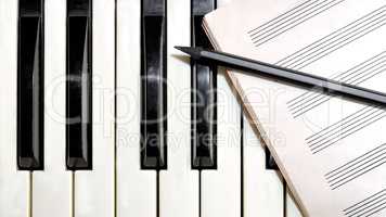 Keyboard with music sheet and pencil
