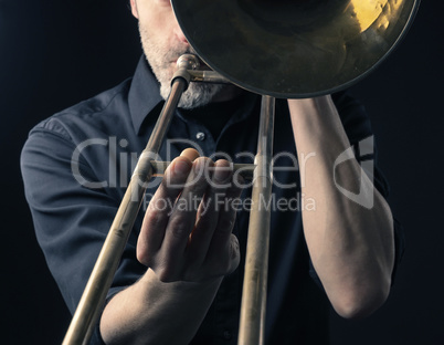 Playing trombone, close up shot