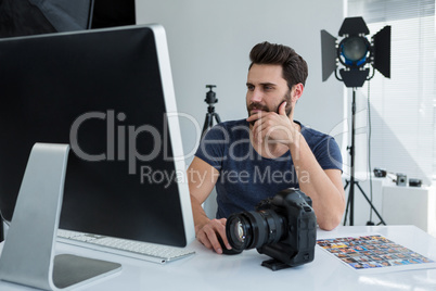 Photographer working over computer at desk