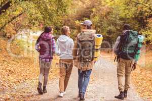 Young backpackers in autumn forest