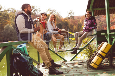 Young travelers resting near river