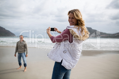 Portrait of mature woman clicking a picture of man