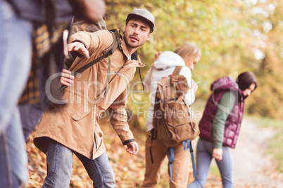 Friends backpackers in autumn forest