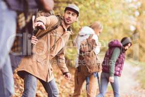 Friends backpackers in autumn forest