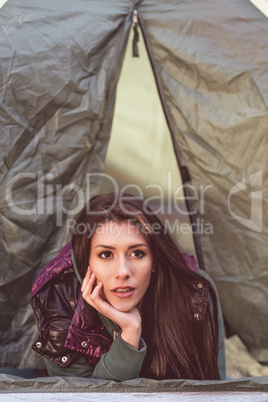 Woman laying in opened tent