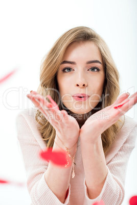 Woman blowing paper hearts