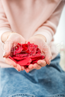 Woman holding red paper hearts