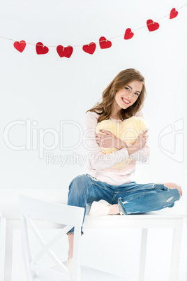 Woman with heart shaped pillow