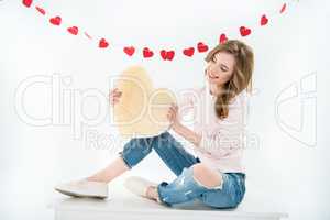 Woman with heart shaped pillow