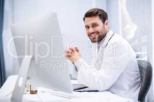 Portrait of male doctor sitting at desk