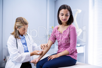 Doctor giving an injection to the patient