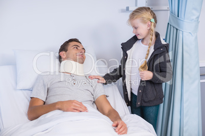 Smiling daughter comforting her sick father