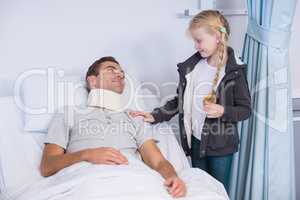 Smiling daughter comforting her sick father