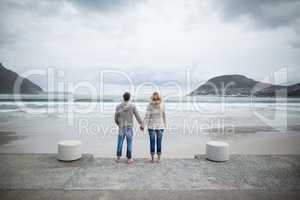 Couple standing with holding hands on the beach
