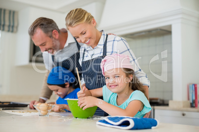 Parents and kids preparing food in kitchen