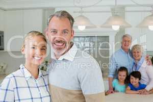 Portrait of happy couple standing at kitchen
