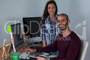 Photographer working at his desk with colleague