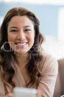 Portrait of smiling woman in living room