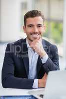 Businessman sitting with laptop