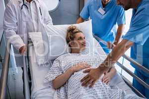 Team of doctors examining pregnant woman