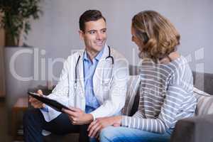 Doctor discussing a medical report with woman