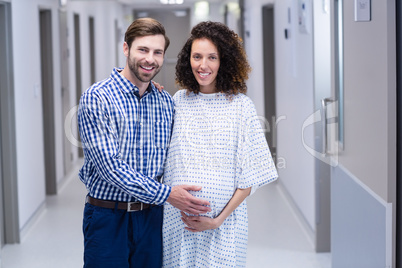 Portrait of happy couple standing in corridor