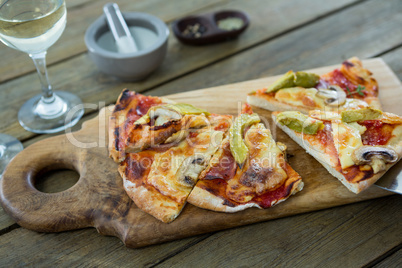 Slices of italian pizza served in a chopping board
