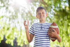 Boy holding asthma inhaler and a rugby ball