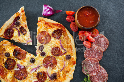 Italian pizza with various ingredients and salami