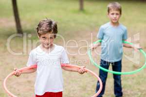 Two boys playing with hula hoop