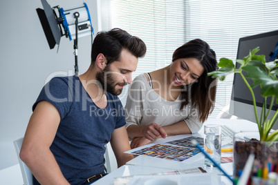 Photographers working together at desk