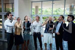 Business executives having champagne at conference center