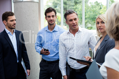 Business executives interacting in a conference center lobby