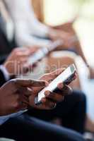 Close-up of business executives using mobile phone