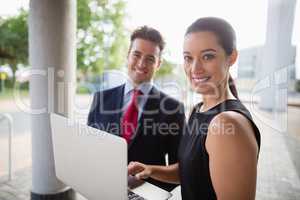Businessman and colleague holding laptop