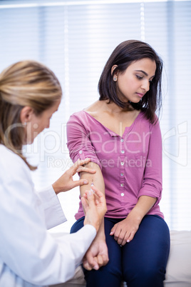 Doctor giving an injection to the patient