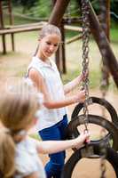 Two girls interacting with each other while playing in park