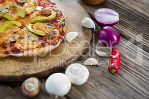 Various species with pizza arranged on wooden tray