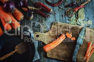 Fresh vegetables, spices and black frying pan for cooking meals