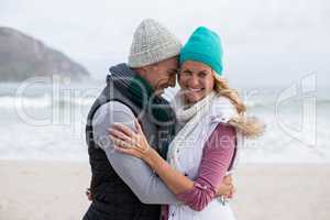 Mature couple embracing each other on the beach