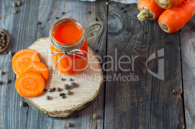 Fresh carrot juice in a glass jar