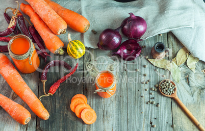 Fresh carrots and carrot juice in a glass container