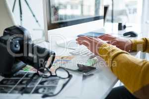 Male photographer working over computer at desk