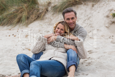 Mature couple embracing each other on the beach